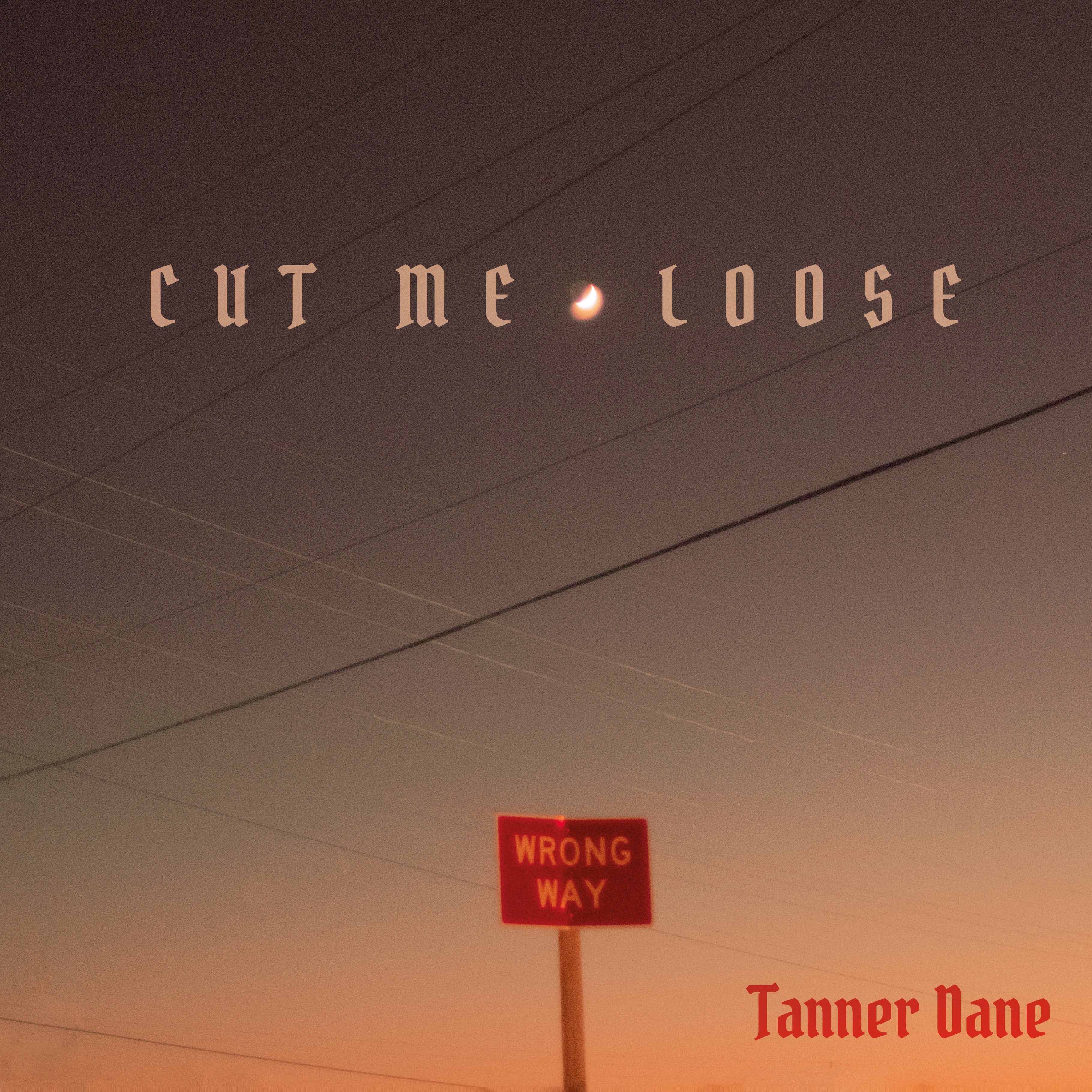 EP cover for Tanner Dane's "Cut Me Loose" showing a warm sunset sky with power lines, a red "Wrong Way" road sign, and the artist name in red gothic lettering
